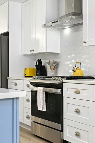 a kitchen with a stove and cabinets