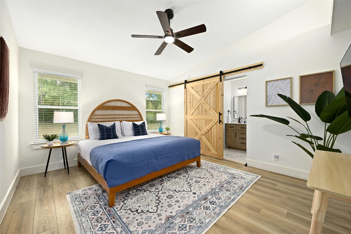 9414 Meadow Vale Austin, TX 78758 - Photo 22 of 37 a bedroom with a bed a window and a flat screen tv