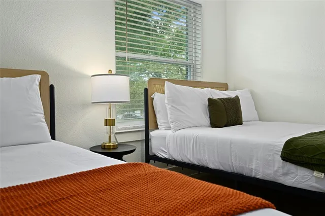 a bedroom with bed and window