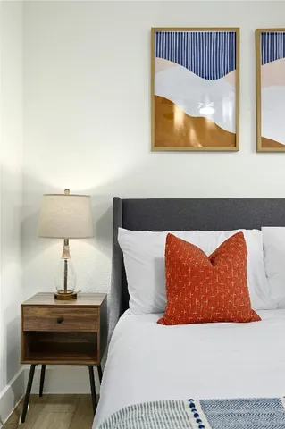 a bedroom with a bed and a lamp