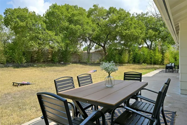 a view of a dinning table and chairs in the patio