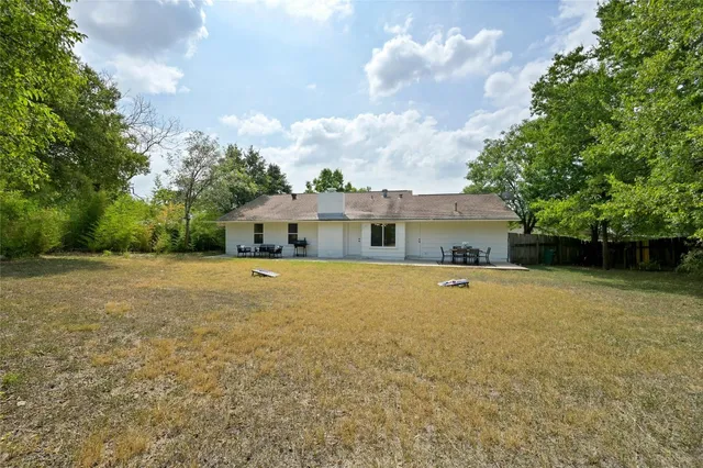 a front view of house with yard and trees