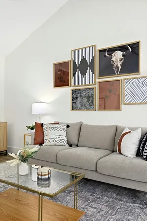 a living room with furniture and painting on the wall