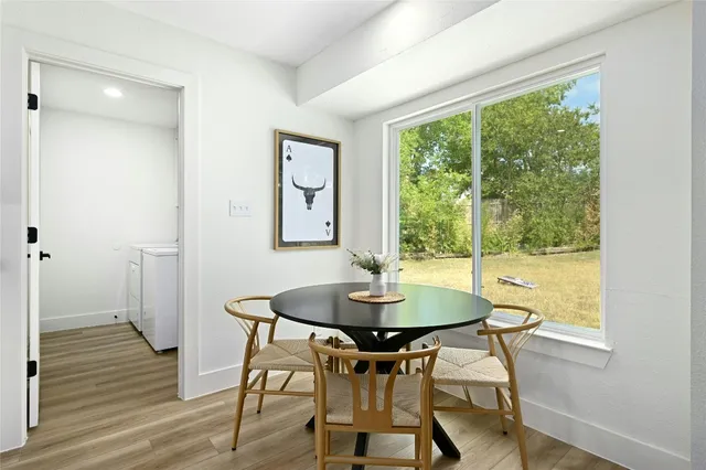 a dining room with furniture and wooden floor