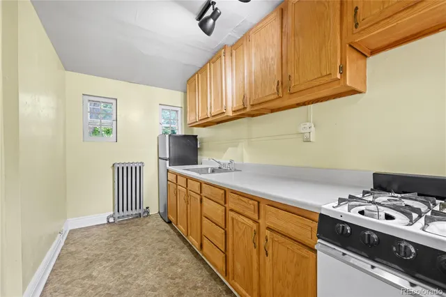 a kitchen with stainless steel appliances granite countertop a stove and a sink