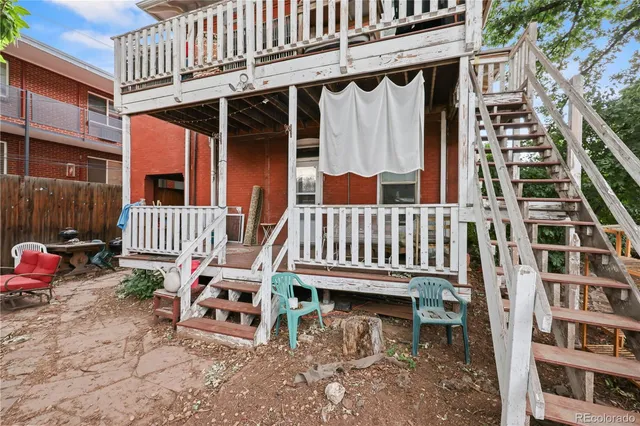 a view of a chair and tables in the roof deck
