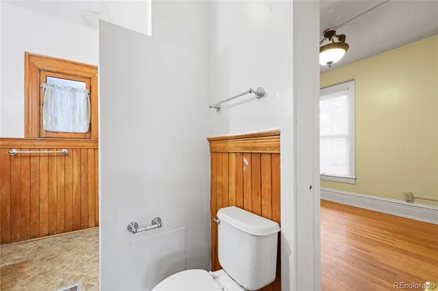 a bathroom with a toilet sink tub and mirror