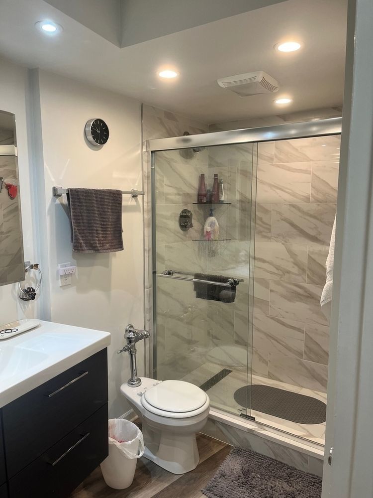 300 North State Street, Unit 3304 Chicago, IL 60654 - Photo 10 of 18 a bathroom with a sink a toilet and shower