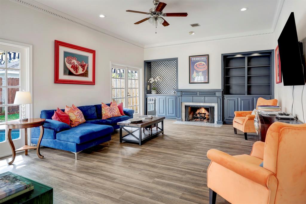 6243 Wickersham Lane Houston, TX 77057 - Photo 1 of 30 a living room with furniture flat screen tv and a fireplace