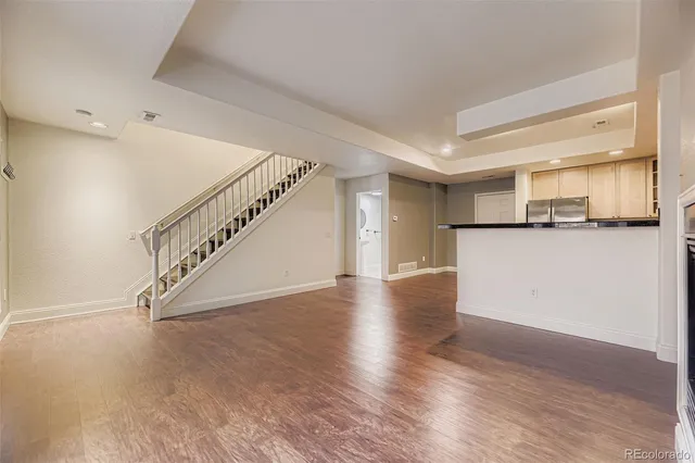 a view of a kitchen with wooden floor and a kitchen