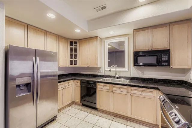 a kitchen with granite countertop stainless steel appliances a sink and counter space
