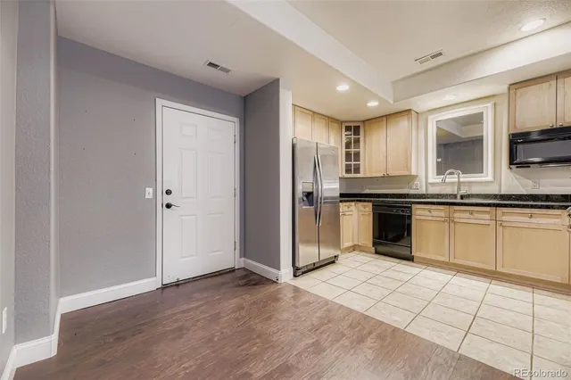 a kitchen with stainless steel appliances granite countertop a refrigerator and a sink