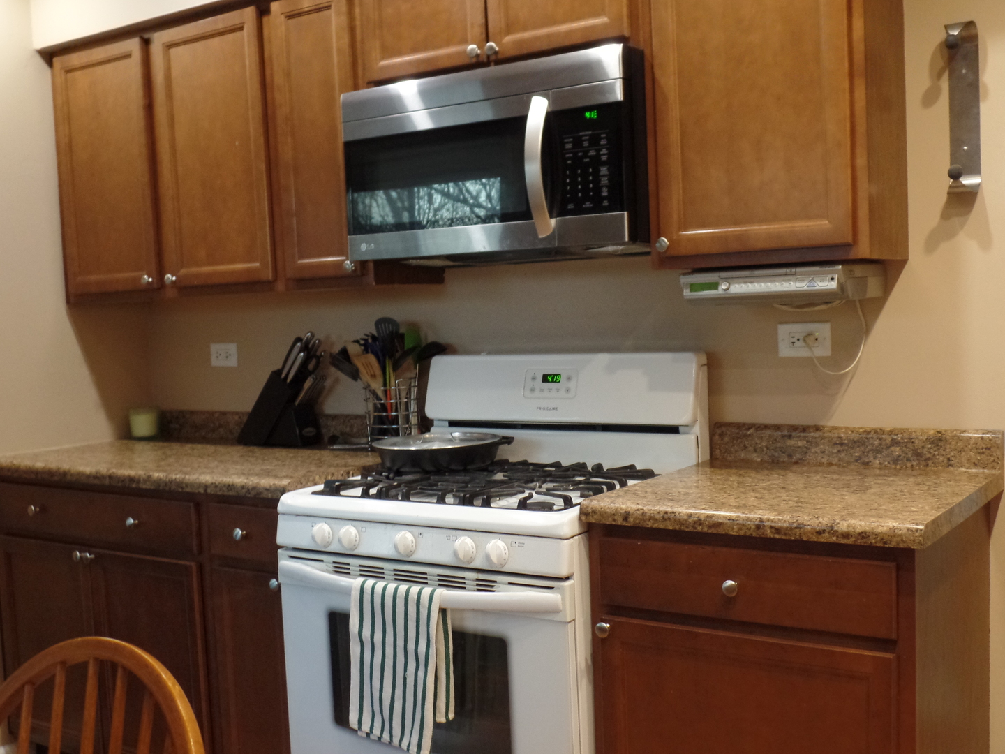 484 Rockhurst Road Bolingbrook, IL 60440 - Photo 11 of 34 a kitchen with stainless steel appliances granite countertop a stove a microwave and cabinets