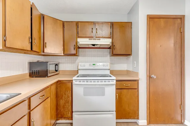 a kitchen with a stove top oven sink and a refrigerator