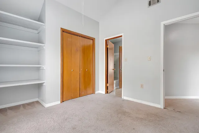 a view of an empty room with a closet