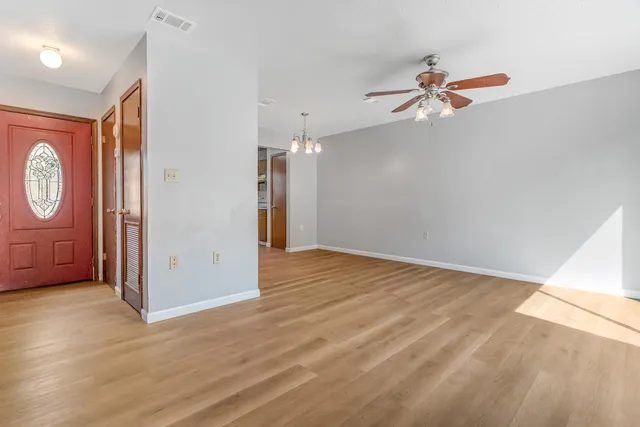 a view of empty room with wooden floor