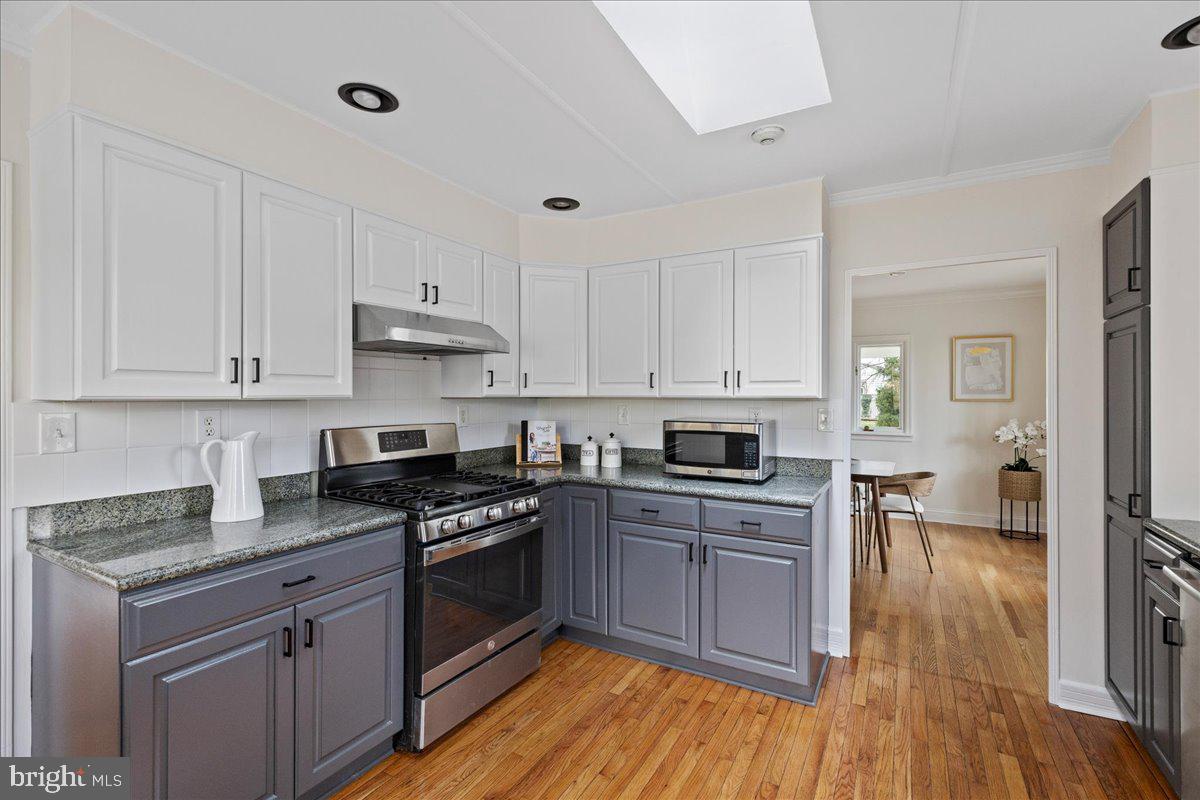 237 Elm Road Princeton, NJ 08540 - Photo 4 of 26 a kitchen with cabinets wooden floor and a sink