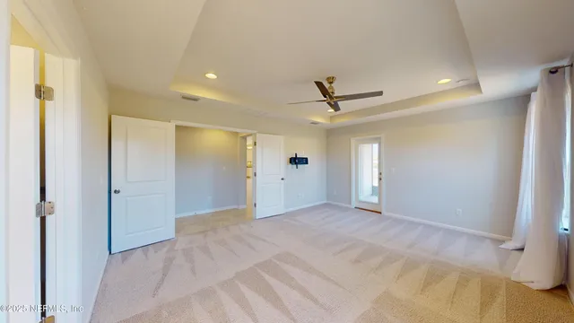 a bathroom with a granite countertop sink mirror bathtub and next to a window