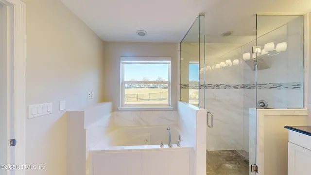a bathroom with a granite countertop sink a large mirror and a shower