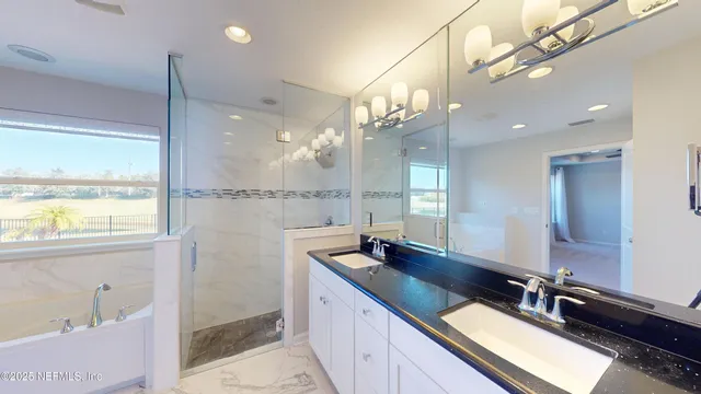 a bathroom with a shower and a glass door