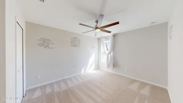 a view of a livingroom with a ceiling fan
