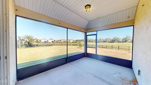 a view of an house with backyard and a tree