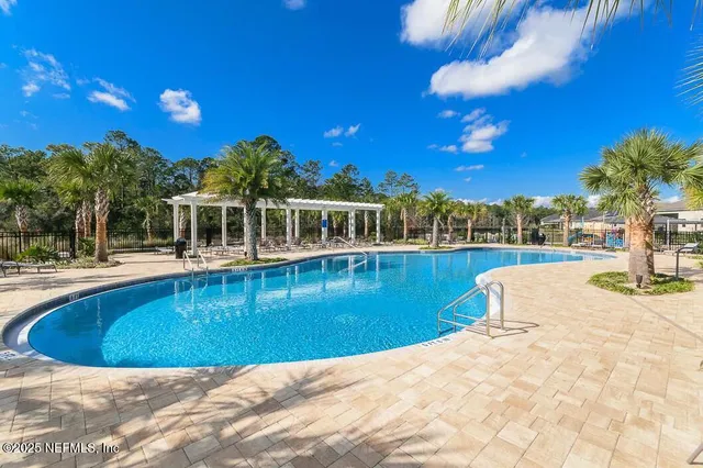 a view of a swimming pool with outdoor seating