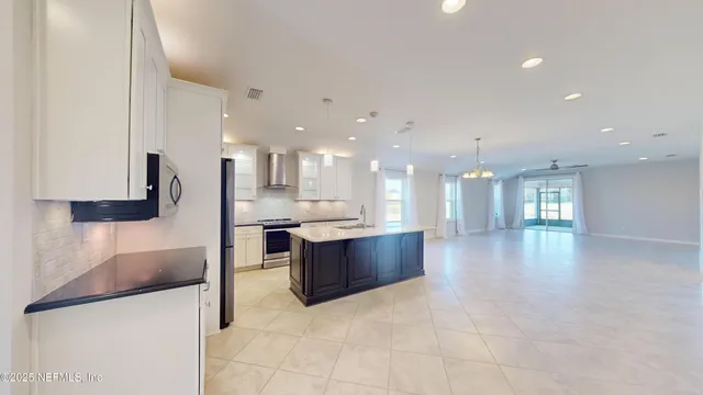 a large kitchen with a large counter top appliances and cabinets