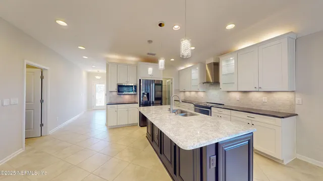 a kitchen with a sink a counter top stainless steel appliances and cabinets