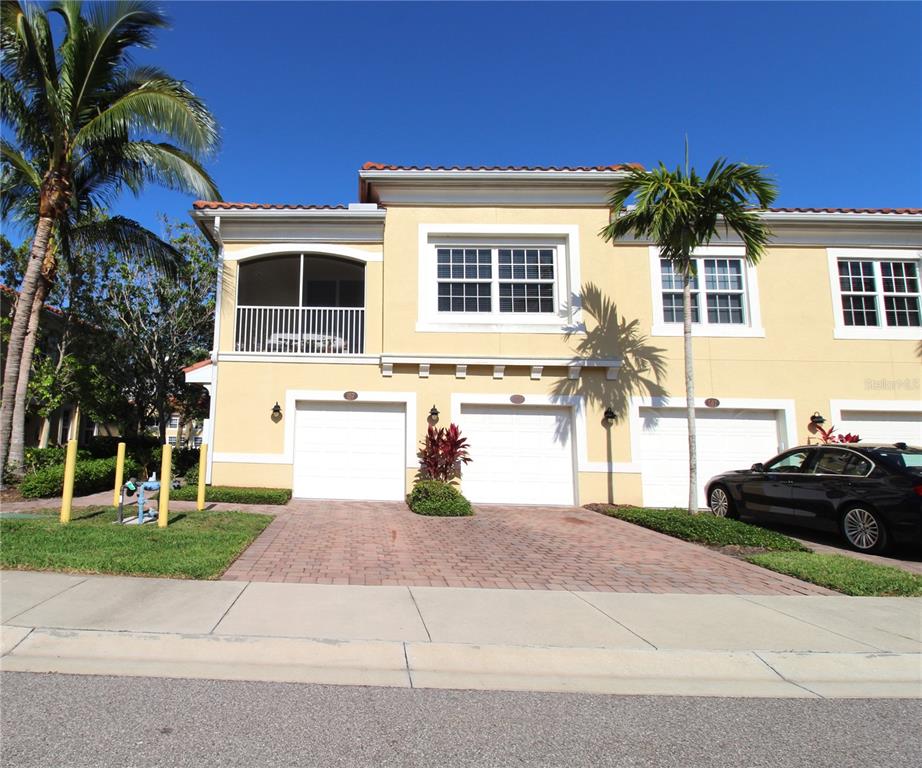 a front view of a house with a yard and a garage