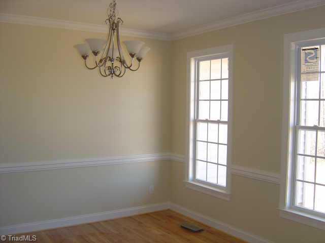 4002 Ballard Farm Road Colfax, NC 27235 - Photo 3 of 8 Other. Dining room with hardwoods, crown molding, and chair rail opens into two story foyer and connects with kitchen