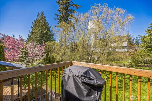 a view of a balcony with wooden fence and floor