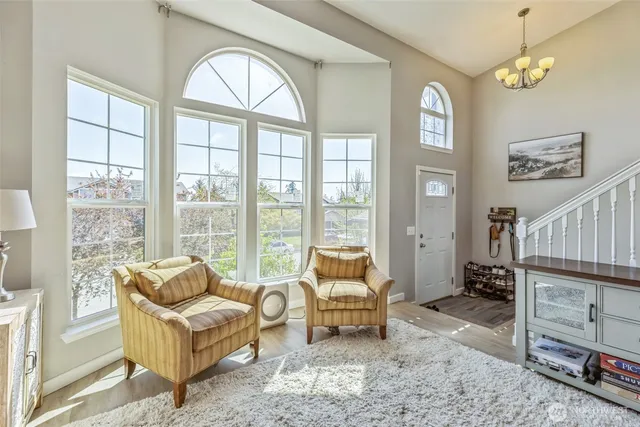 a living room with furniture and a floor to ceiling window