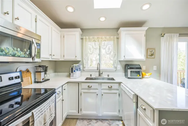 a kitchen with a sink stove and cabinets