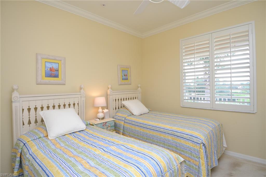 2750 Cypress Trace Circle, Unit 2636 Naples, FL 34119 - Photo 18 of 26 a bedroom with beds and a window