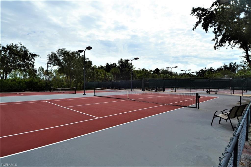 2750 Cypress Trace Circle, Unit 2636 Naples, FL 34119 - Photo 26 of 26 a view of tennis court with chairs