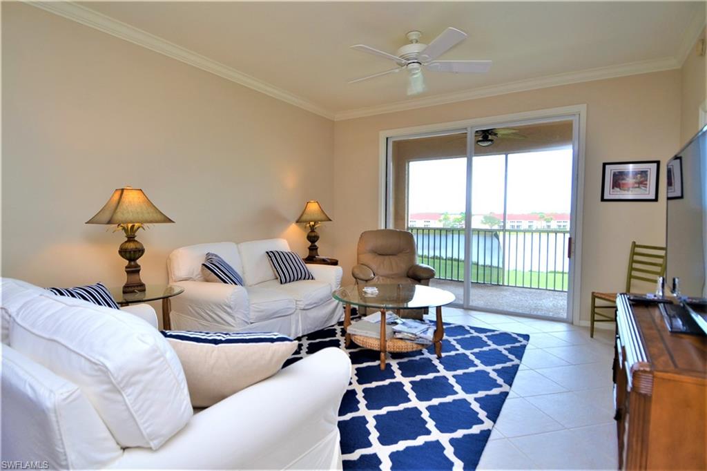 2750 Cypress Trace Circle, Unit 2636 Naples, FL 34119 - Photo 4 of 26 a living room with furniture and a rug