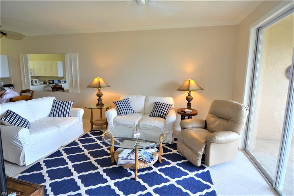 2750 Cypress Trace Circle, Unit 2636 Naples, FL 34119 - Photo 5 of 26 a living room with furniture and a rug