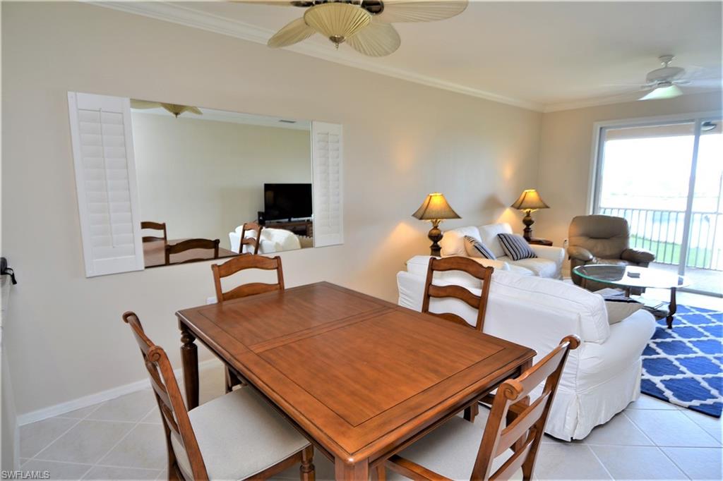 2750 Cypress Trace Circle, Unit 2636 Naples, FL 34119 - Photo 6 of 26 a dining room with furniture and wooden floor