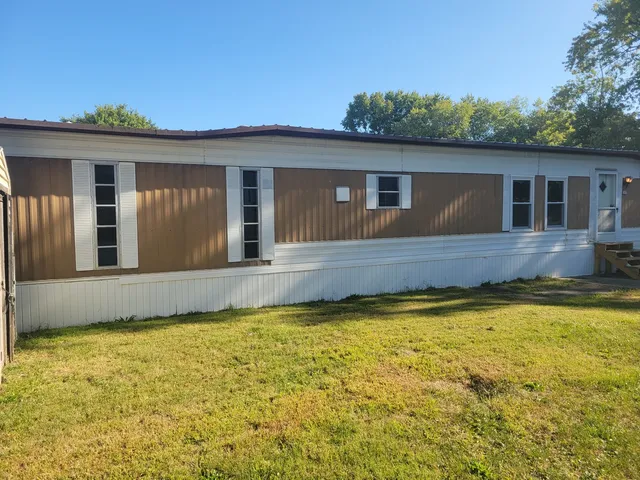 a house view with swimming pool in front of it