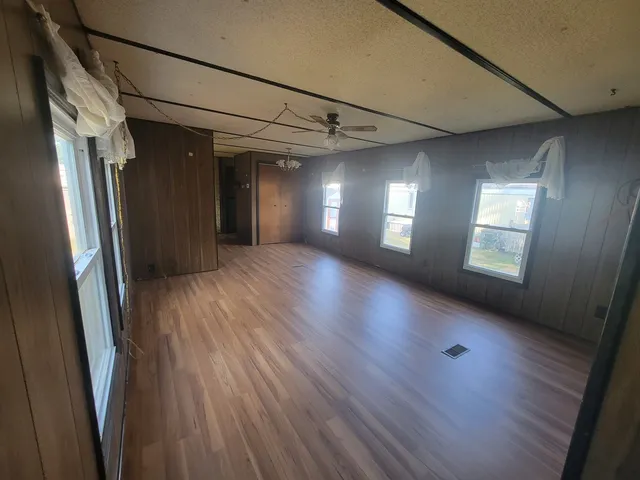a view of a room with wooden floors and a window