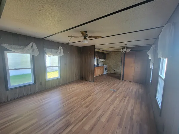a kitchen with stainless steel appliances granite countertop a sink and wooden floor
