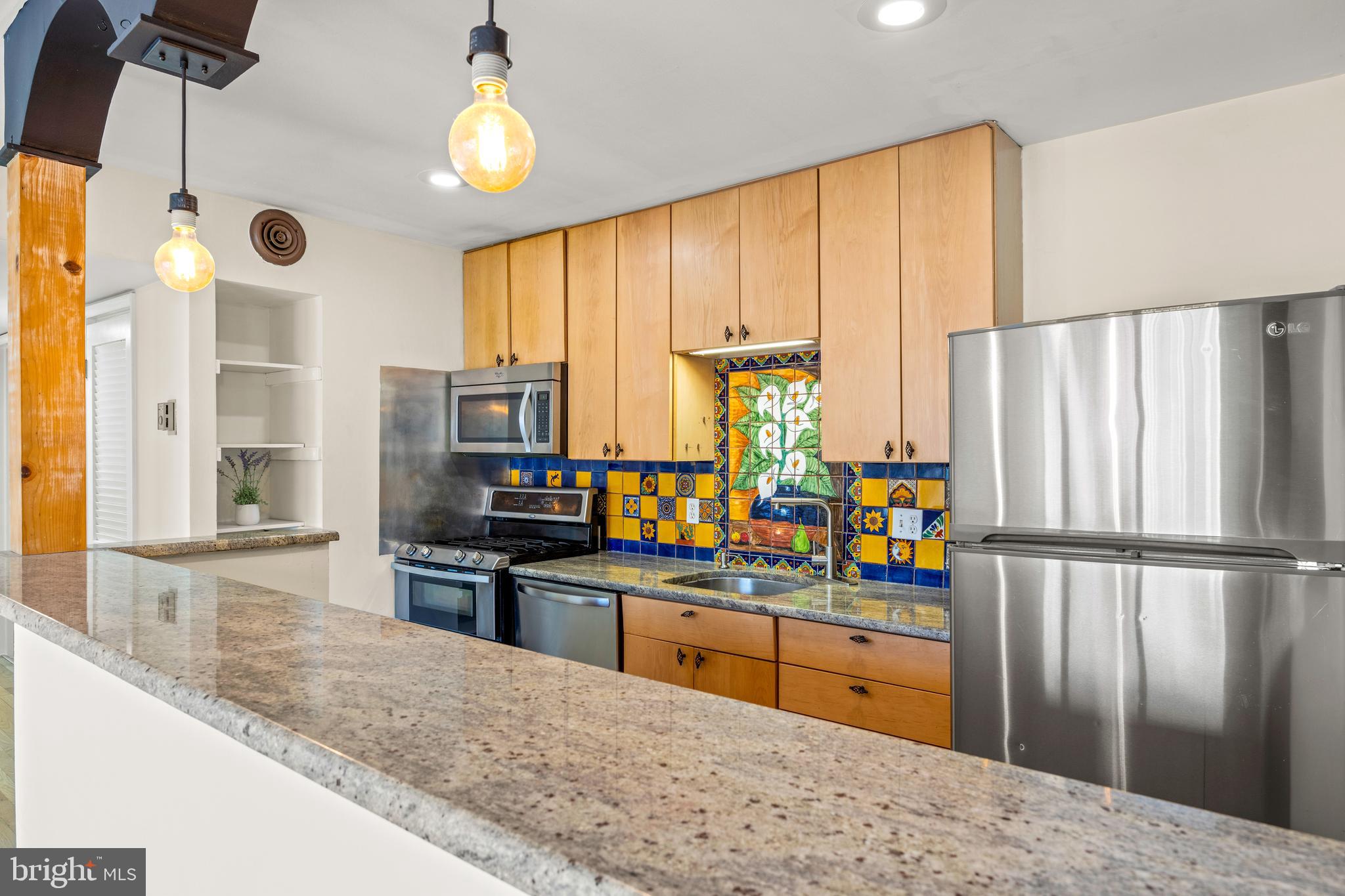 3736 Bel Pre Road, Unit 37367 Silver Spring, MD 20906 - Photo 12 of 27 a kitchen with stainless steel appliances granite countertop a refrigerator a stove and a sink with wooden floor