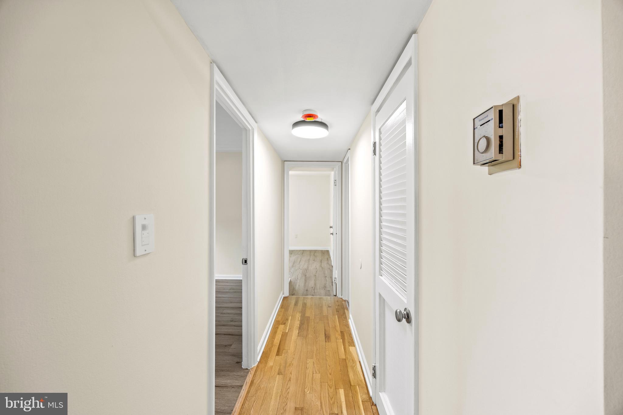 3736 Bel Pre Road, Unit 37367 Silver Spring, MD 20906 - Photo 14 of 27 a view of a hallway with wooden floor and staircase