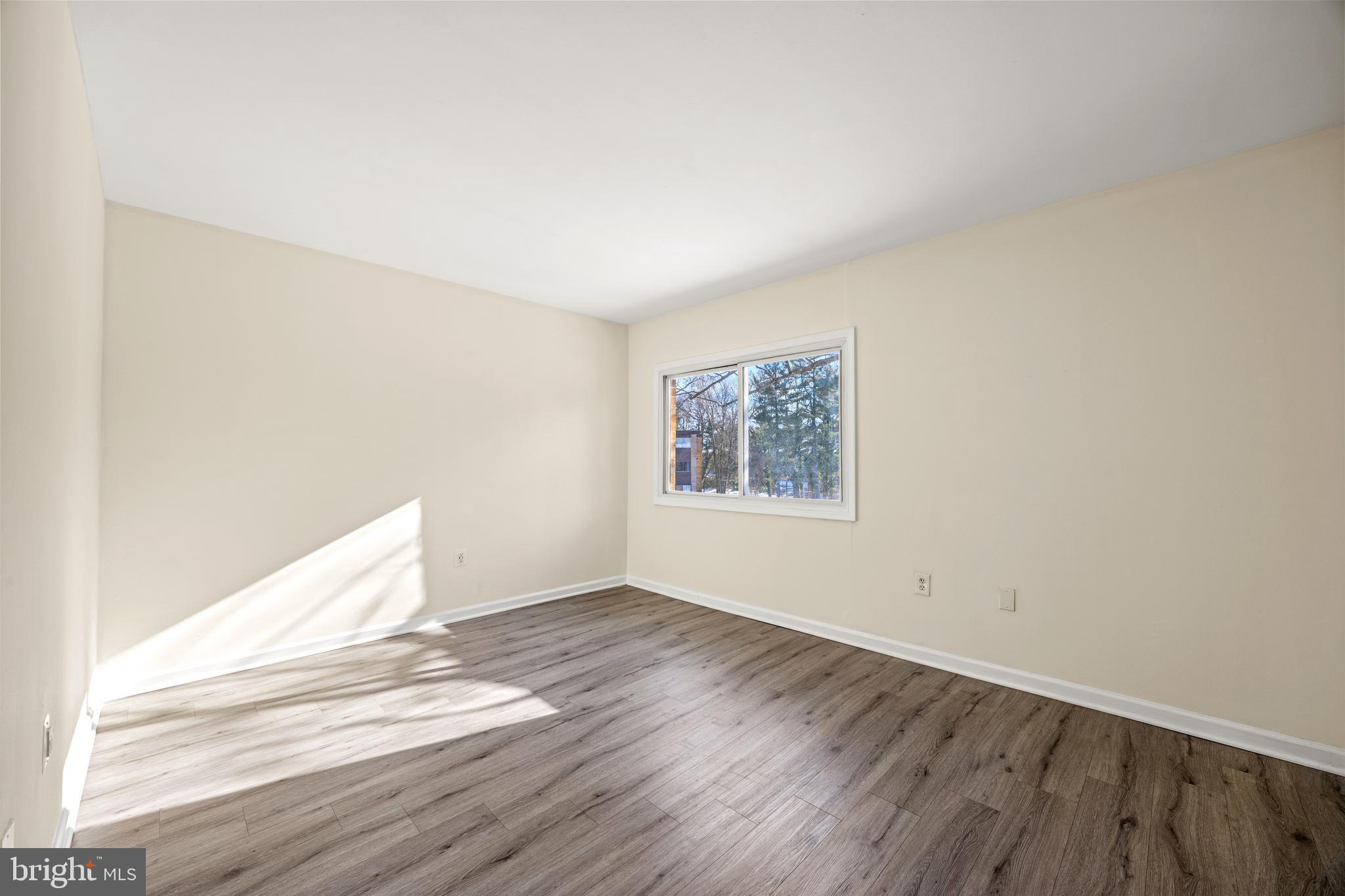 3736 Bel Pre Road, Unit 37367 Silver Spring, MD 20906 - Photo 15 of 27 an empty room with wooden floor and windows