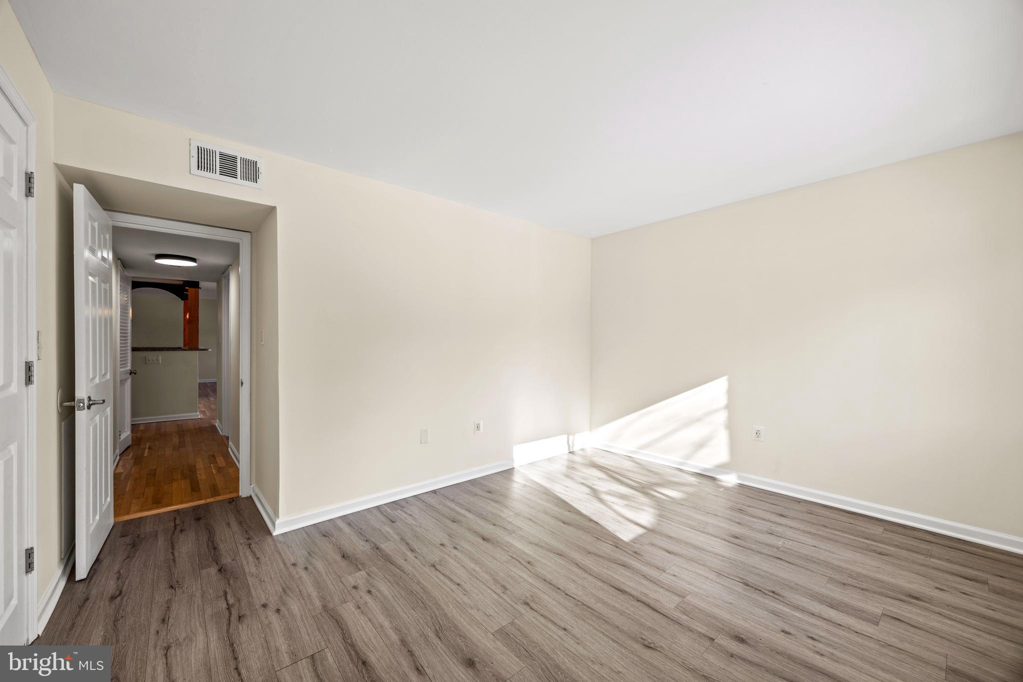 3736 Bel Pre Road, Unit 37367 Silver Spring, MD 20906 - Photo 17 of 27 a view of empty room with wooden floor