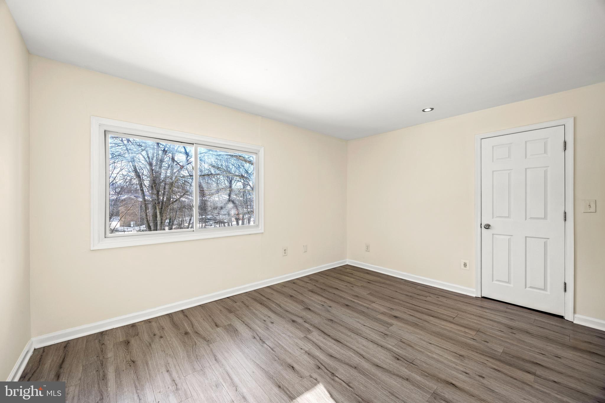 3736 Bel Pre Road, Unit 37367 Silver Spring, MD 20906 - Photo 18 of 27 an empty room with wooden floor and windows