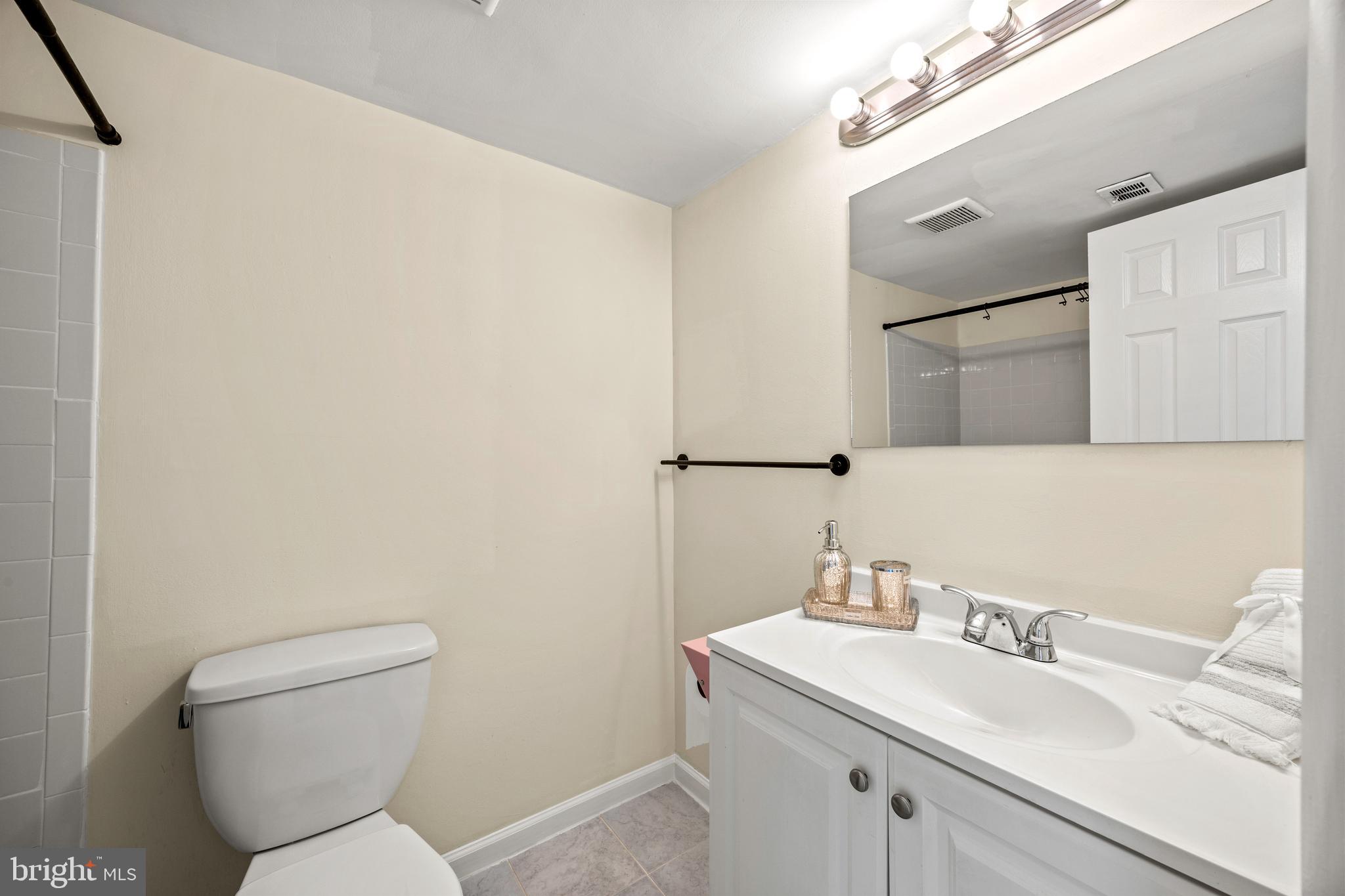 3736 Bel Pre Road, Unit 37367 Silver Spring, MD 20906 - Photo 20 of 27 a bathroom with a toilet sink and mirror