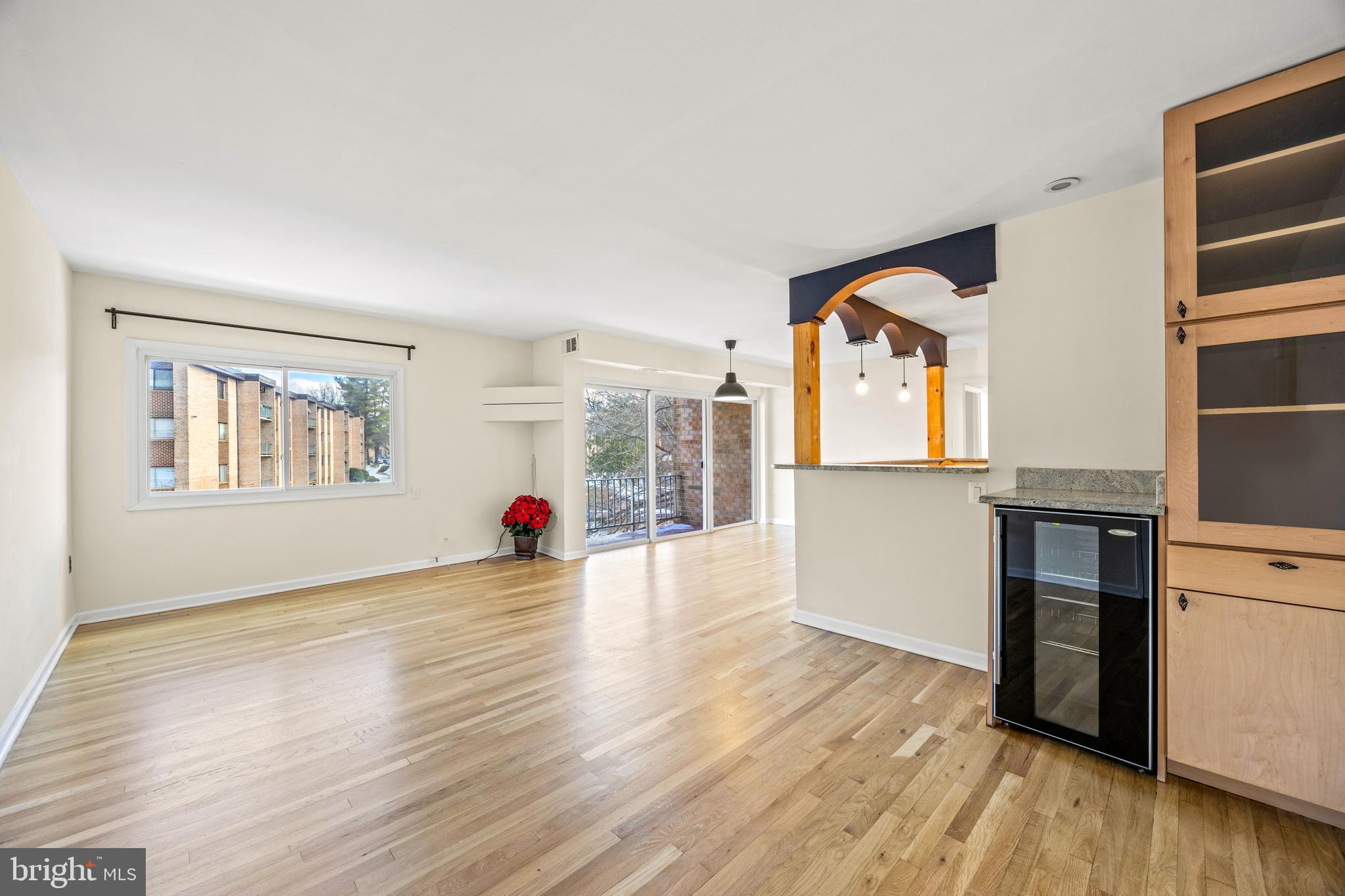 3736 Bel Pre Road, Unit 37367 Silver Spring, MD 20906 - Photo 2 of 27 a view of a living room and kitchen with wooden floor