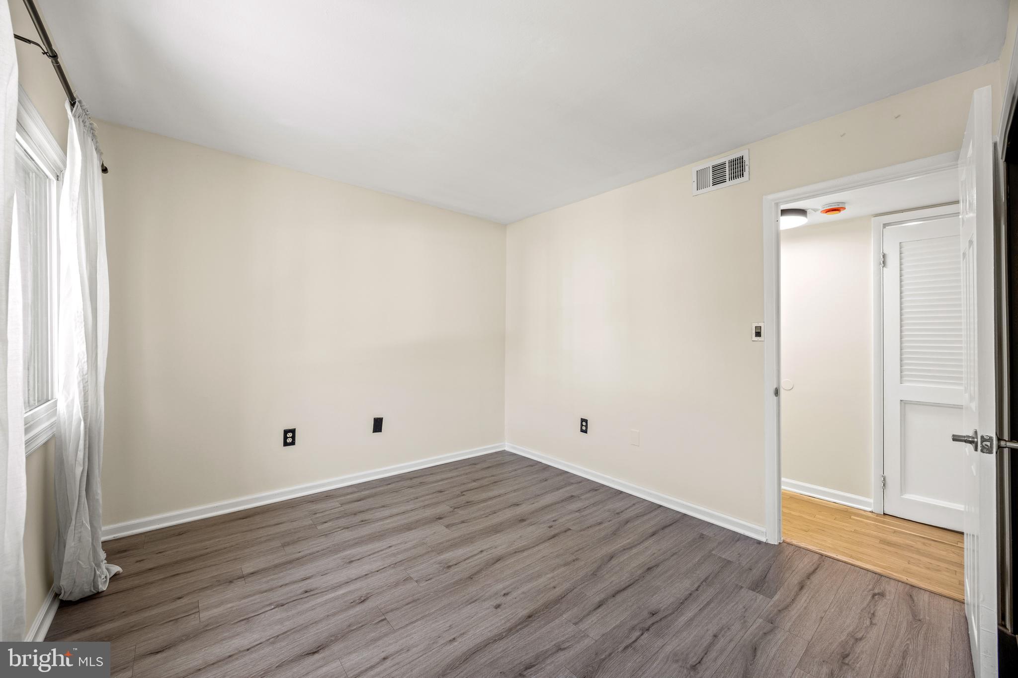 3736 Bel Pre Road, Unit 37367 Silver Spring, MD 20906 - Photo 21 of 27 a view of an empty room with wooden floor